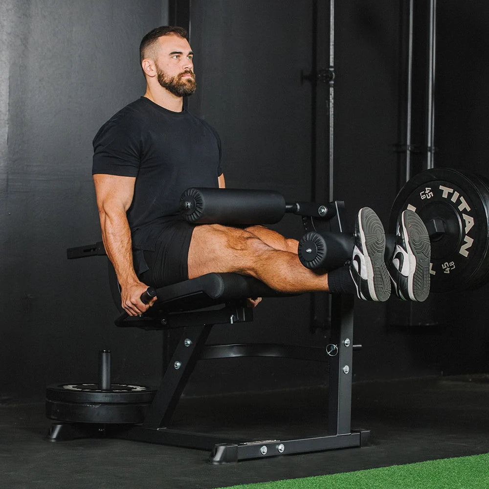 Titan plate-loaded leg extension and leg curl machine, curl extended